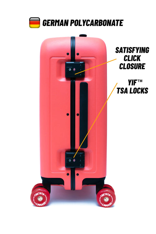 A coral pink hard-shell suitcase shown on a white background with callout text highlighting German polycarbonate construction, click closure, YIF TSA locks, and red wheels.