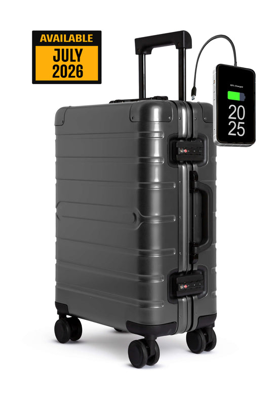 Gray Aluminum suitcase with digital display and available July 2026 label on a white background