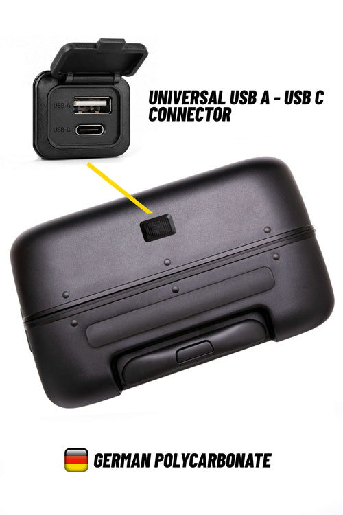 A black hard-shell suitcase or luggage case shown on a white background, with a small inset of a USB charging port on the case and text reading 'UNIVERSAL USB A - USB C CONNECTOR' and 'GERMAN POLYCARBONATE'.
