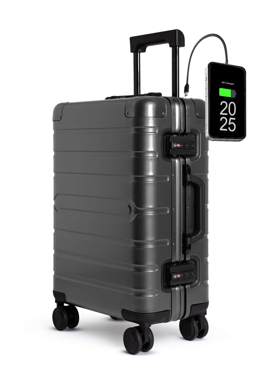 Gray suitcase with digital display and charging cable on a white background