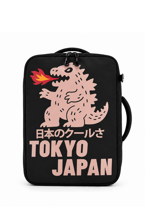 A black soft-sided lunch bag featuring a pink Godzilla graphic with a flame in its mouth, Japanese text, and 'TOKYO JAPAN' in large pink letters, shown on a plain white background.